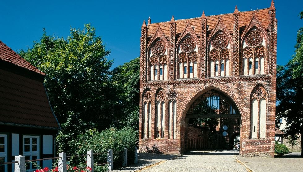 Die vier Backsteintore im mecklenburgischen Neubrandenburg sowie die 2.300 Meter lange Stadtmauer gelten als Baudenkmäler von europäischem Rang. Den wohl schönsten Empfang bereitet das Stargarder Tor mit seinen filigranen Zierelementen., © TMV/Werk3