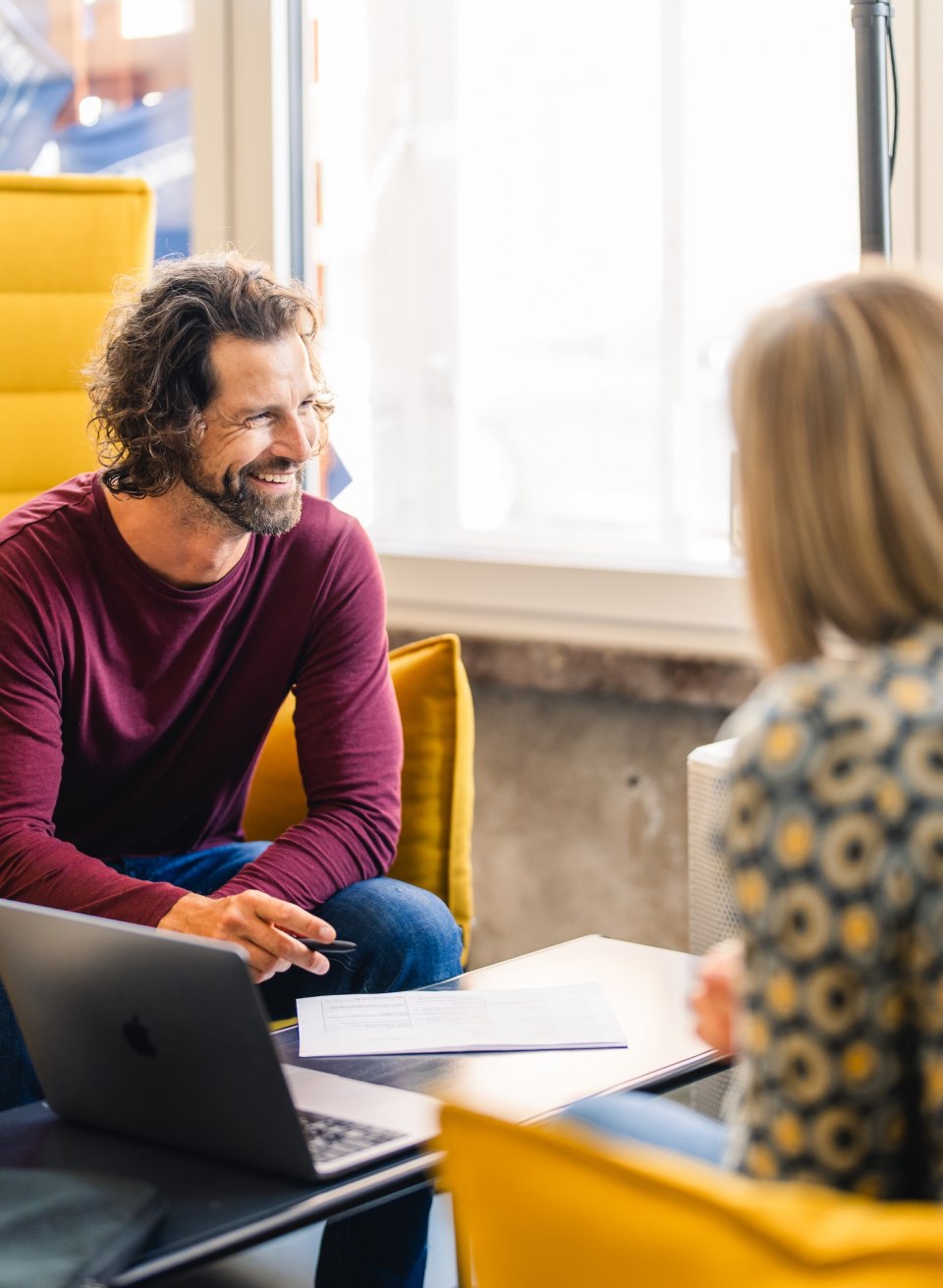  Drei Personen im Gespräch in einer gemütlichen Sitzecke im InnovationPort Wismar, einem modernen Co-Working-Space.