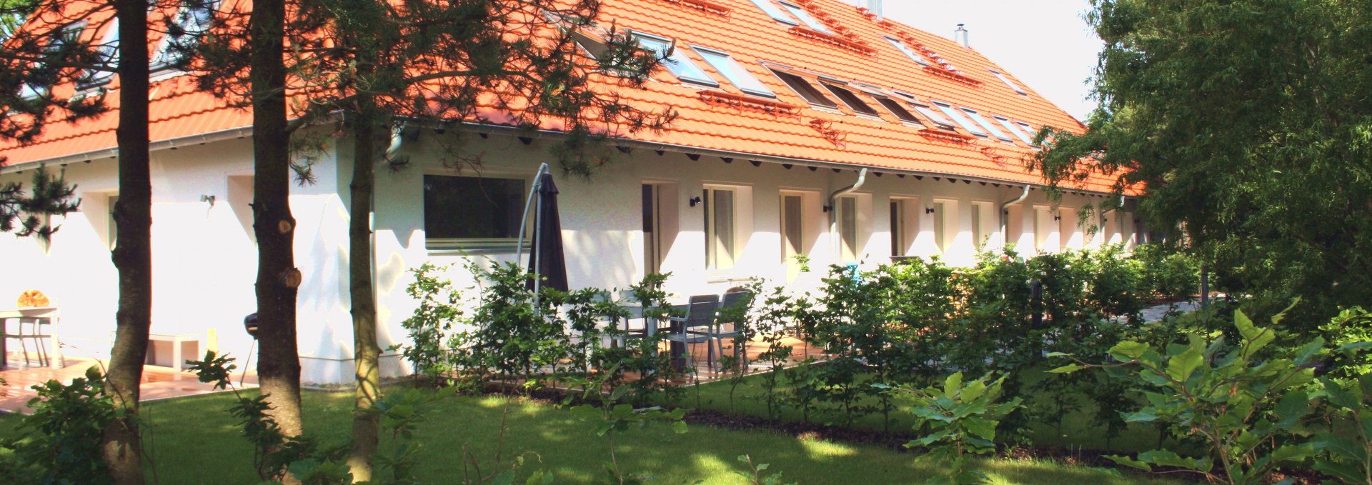 Haus Düne31 ApartmenthausAußenansicht mit Garten und Terrassen, © Haus Düne31