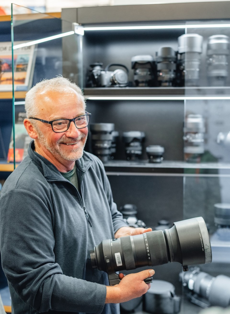 Ein Fotograf zeigt einem Workshop-Teilnehmer im Max Hünten Haus in Zingst eine Auswahl an Kameralinsen.